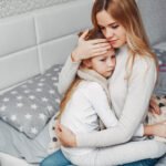 Mother with her illnes daughter in a bedroom